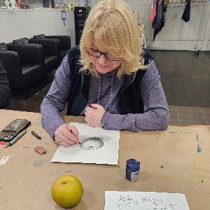 Adult drawing an apple